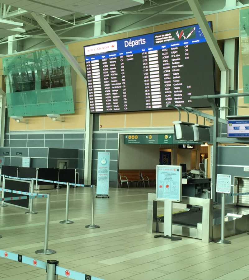 digital screens with arrival and departure information in airport