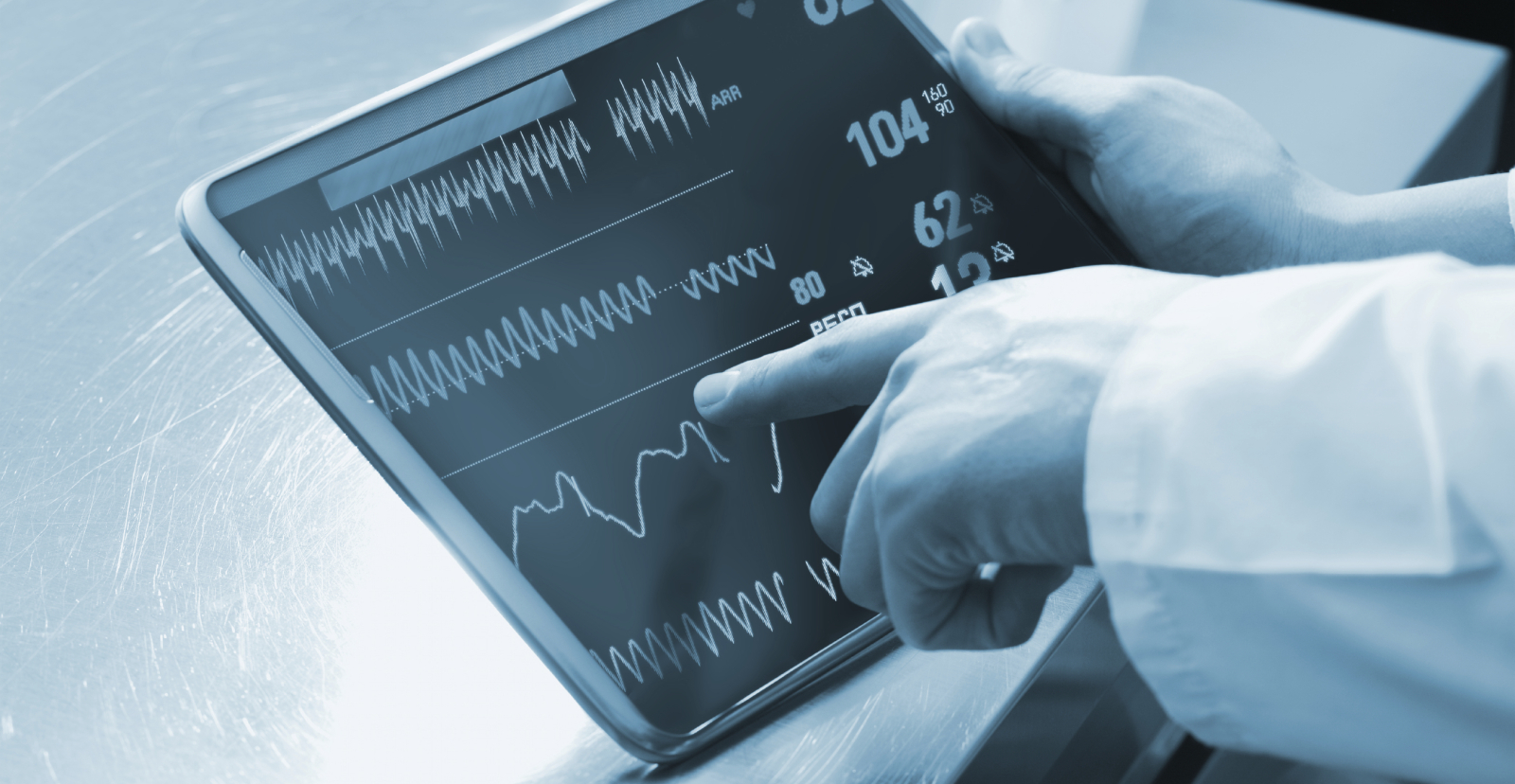 doctor's hand pointing at tablet