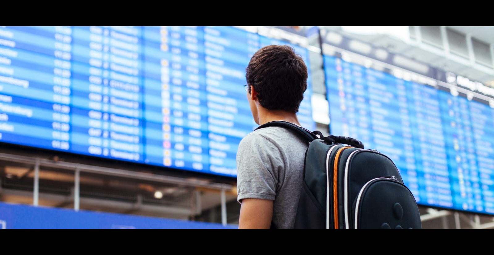 man looking at transportation screen