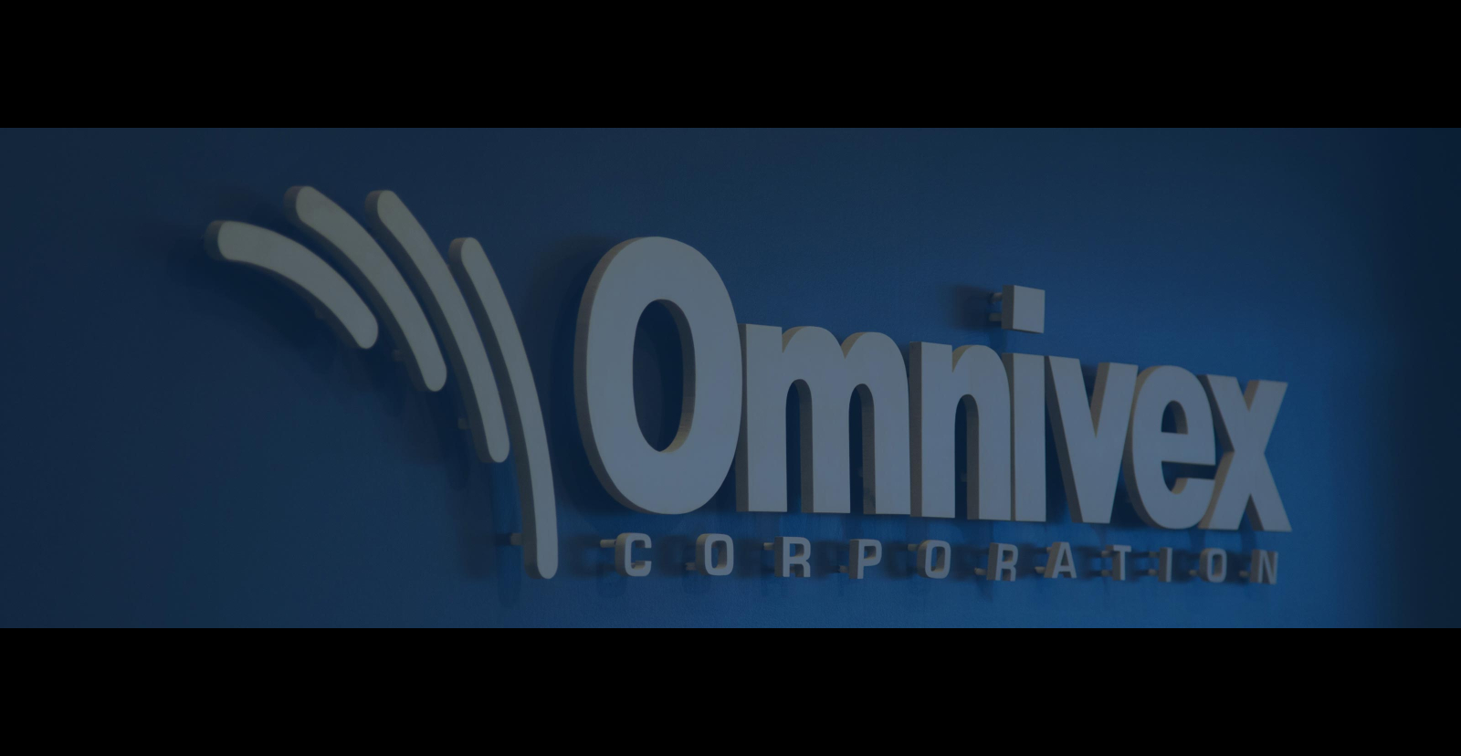 the omnivex logo mounted on a wall