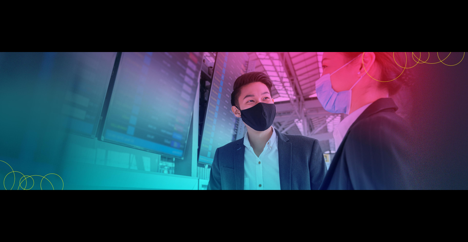 people with masks in front of digital screens