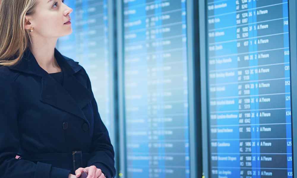 woman looking at transportation schedule screen