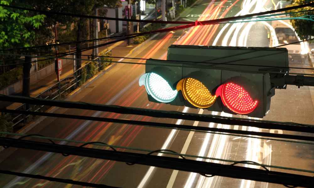 traffic light above darkened city street