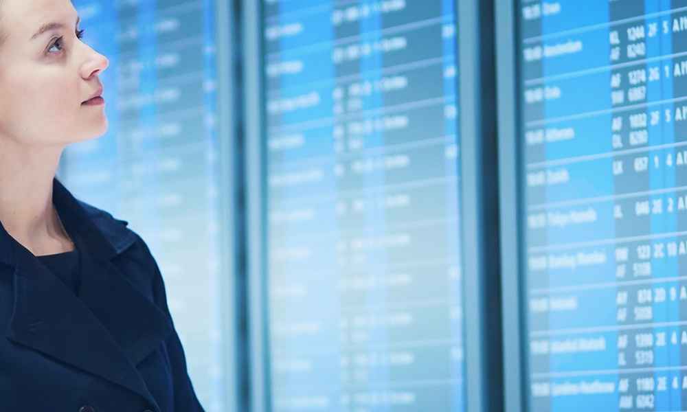 woman looking at transportation schedule screen