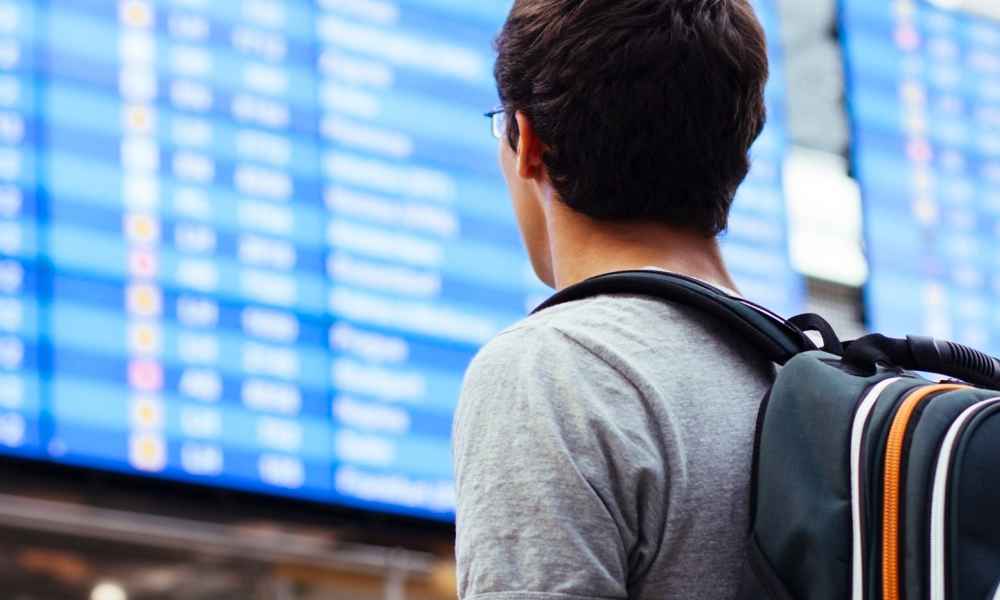 man looking at transportation screen