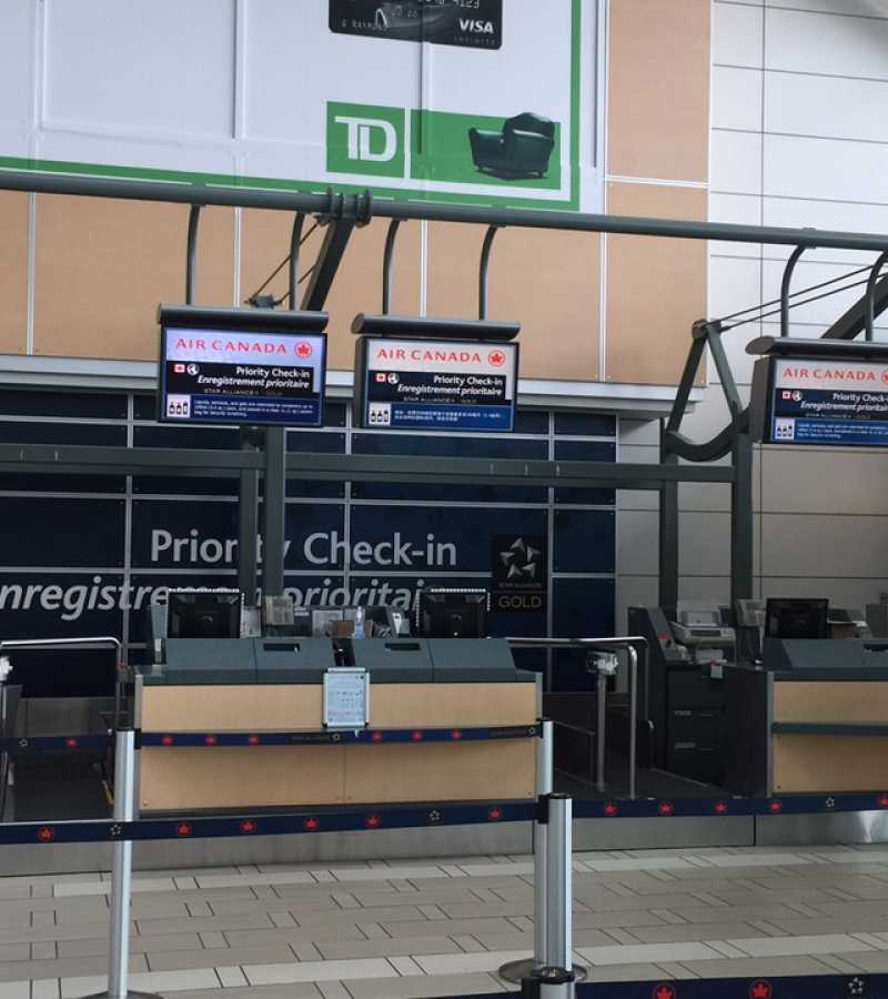 digital screens at checkin counter in airport